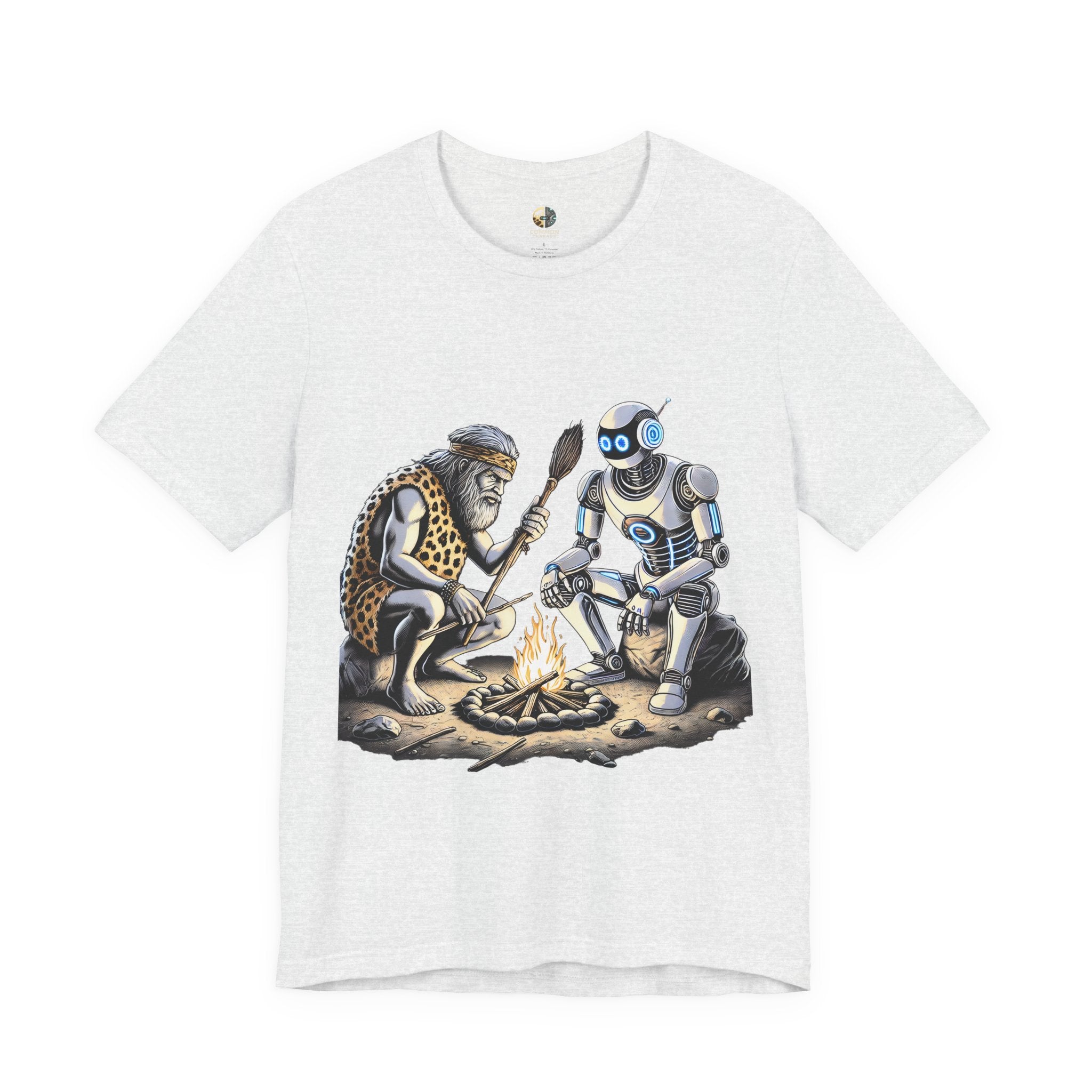 Ash color T-shirt featuring a graphic of a bearded caveman in a leopard-print pelt sitting by a campfire with a futuristic robot
