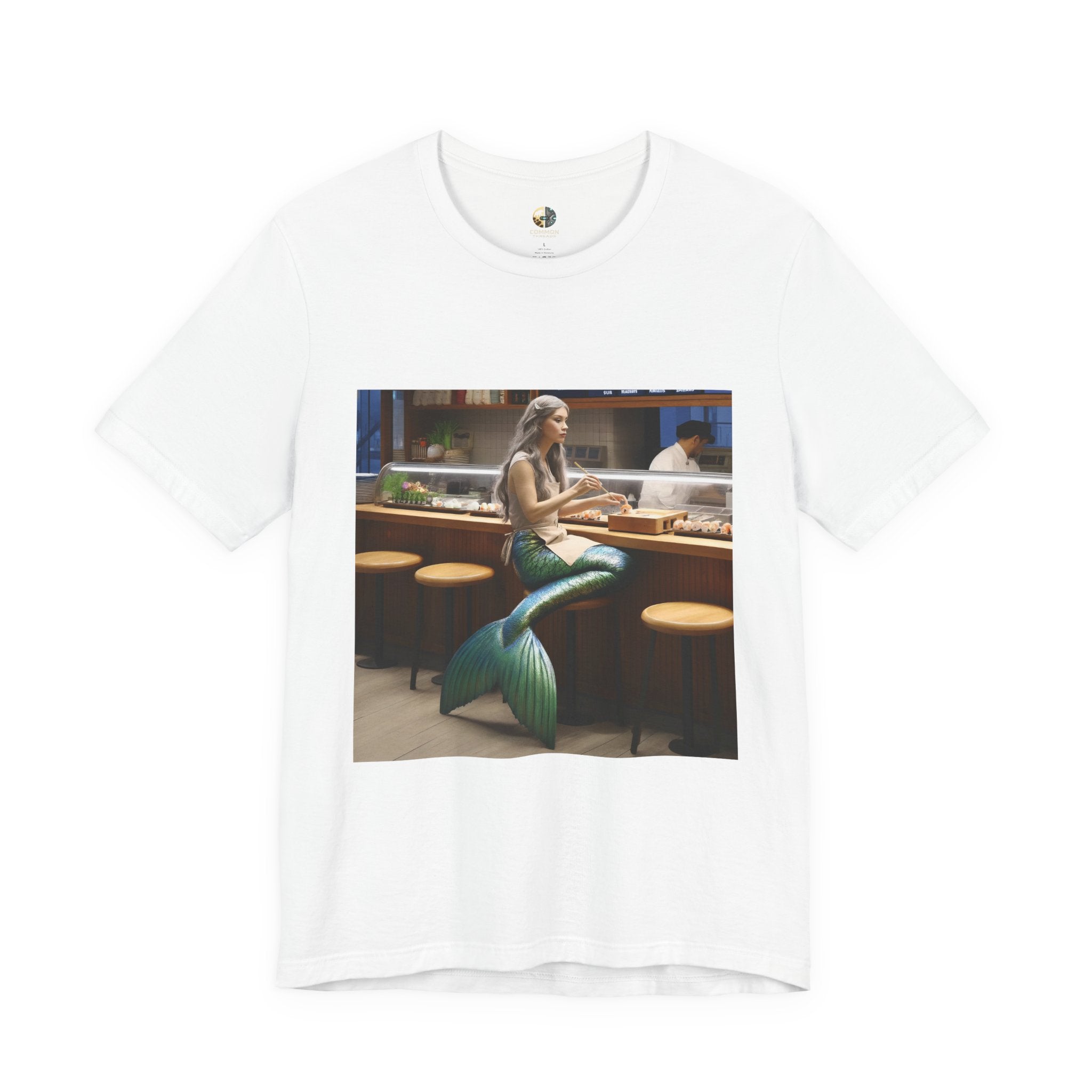 White T-shirt featuring a graphic of a mermaid wearing a chef’s apron sitting at a sushi bar and eating sushi, with a chef behind the counter