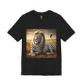 Black T-shirt featuring a lion with distinctive zebra-like stripes lying on dry savanna grass under a clear sky