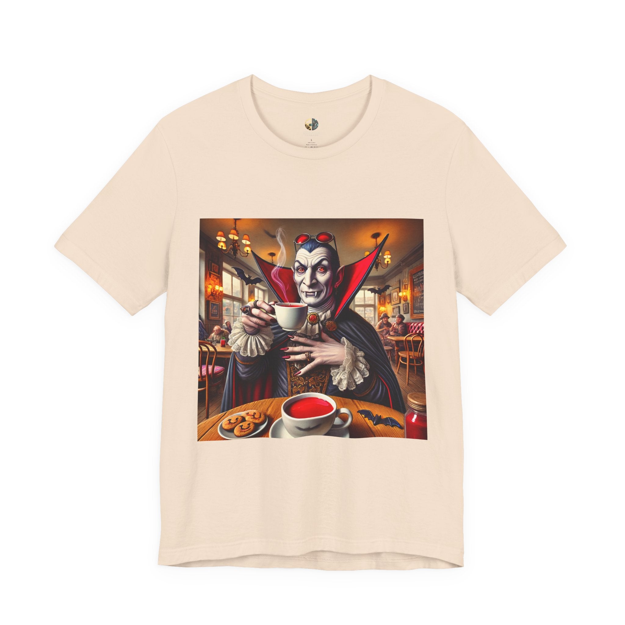 Soft creme T-shirt featuring a classic vampire dressed like Count Dracula sitting in a café, wearing red sunglasses and drinking from a teacup filled with red liquid