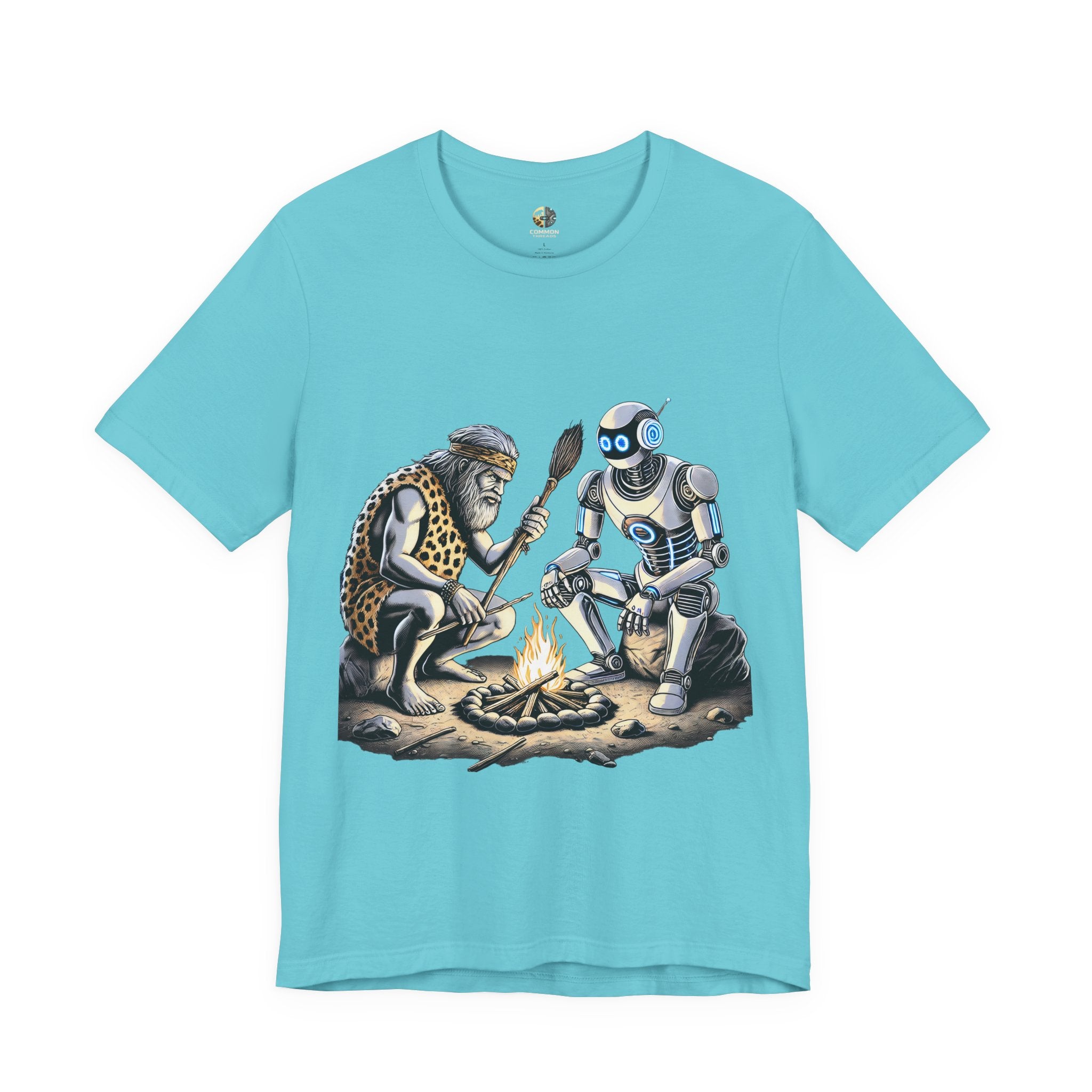 Turquoise T-shirt featuring a graphic of a bearded caveman in a leopard-print pelt sitting by a campfire with a futuristic robot