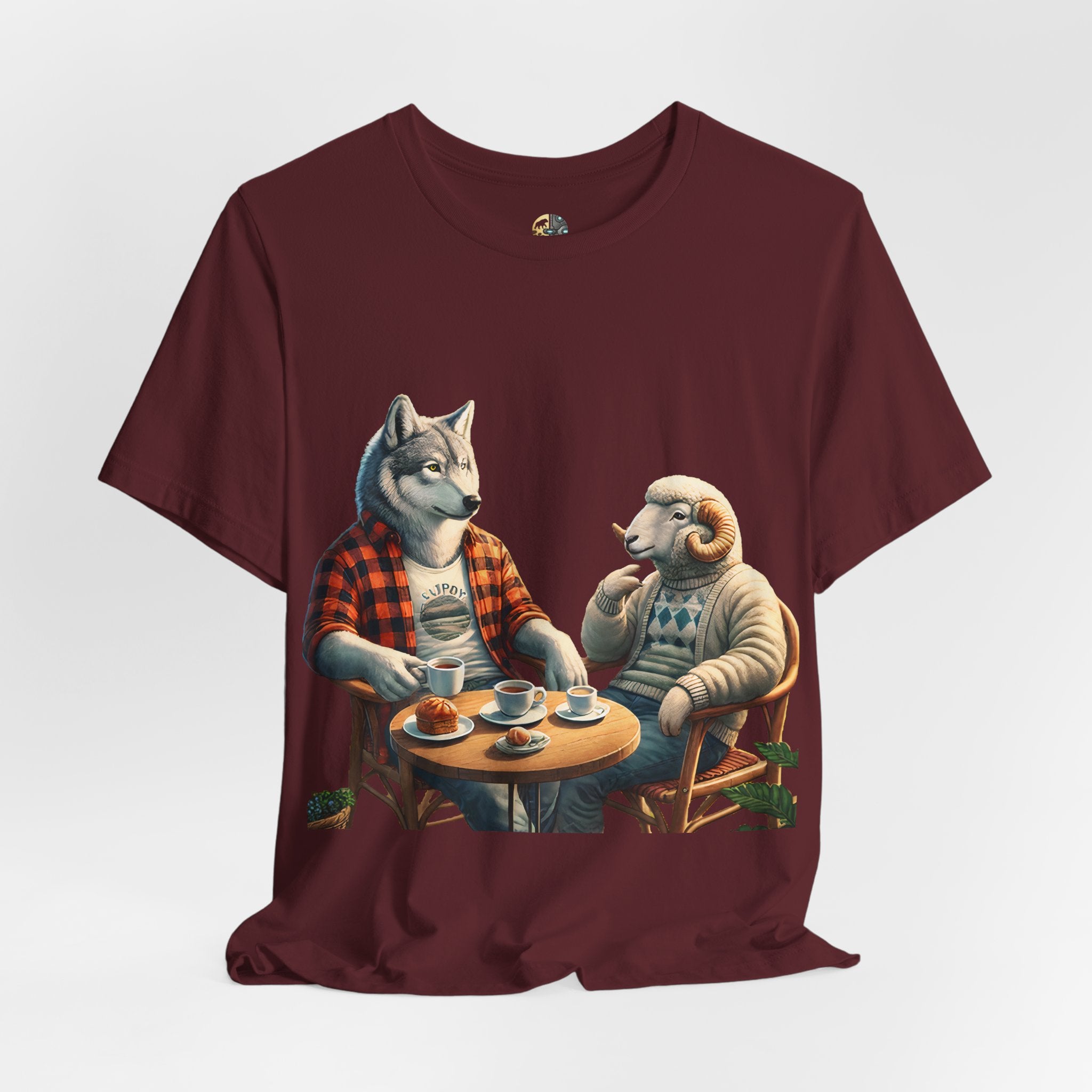 Maroon color T-shirt featuring an anthropomorphic wolf in a flannel shirt and a ram in a patterned sweater sitting at a café table with coffee