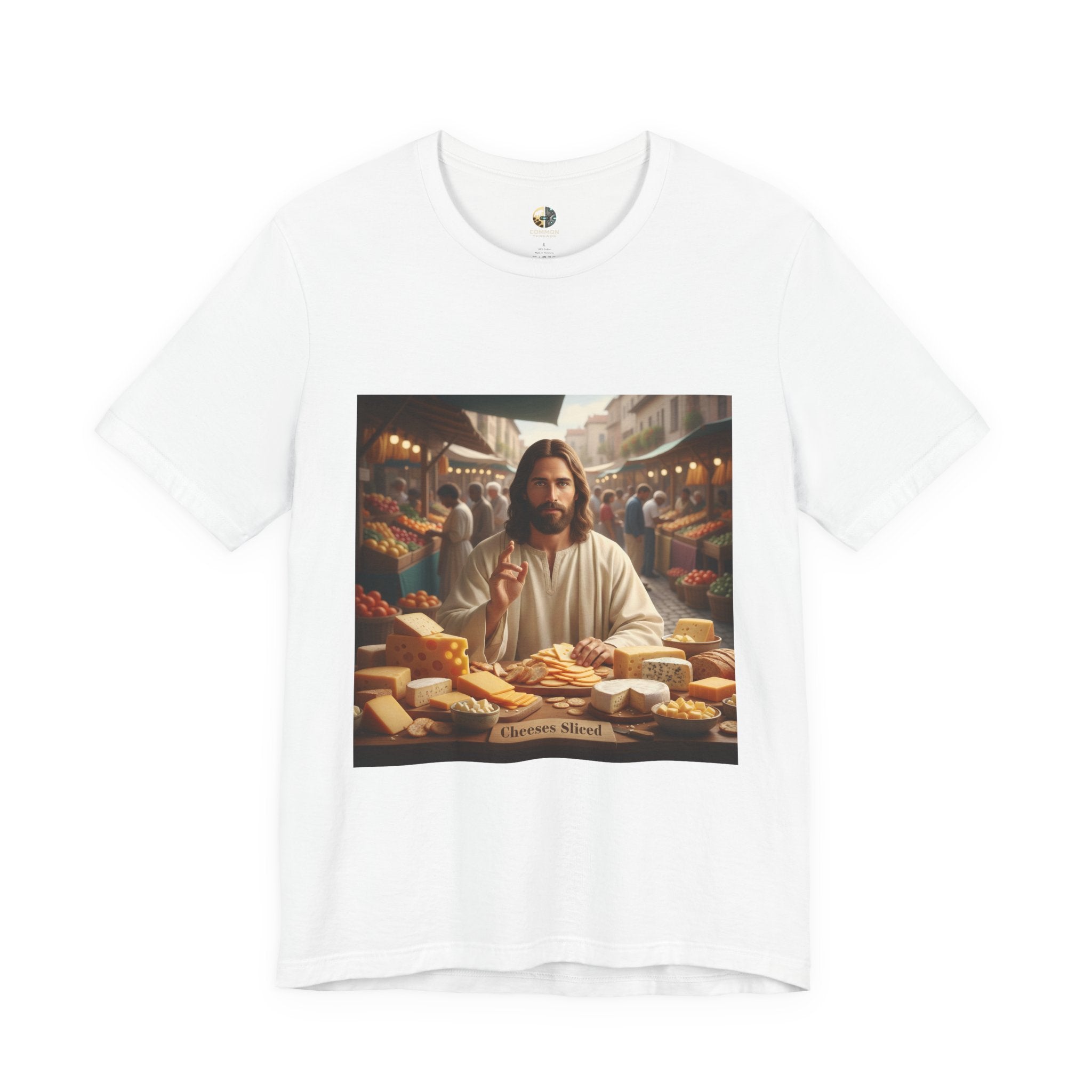 White T-shirt featuring a graphic of Jesus in traditional robes at an ancient marketplace selling assorted cheeses, with a sign reading ‘Cheeses Sliced‘