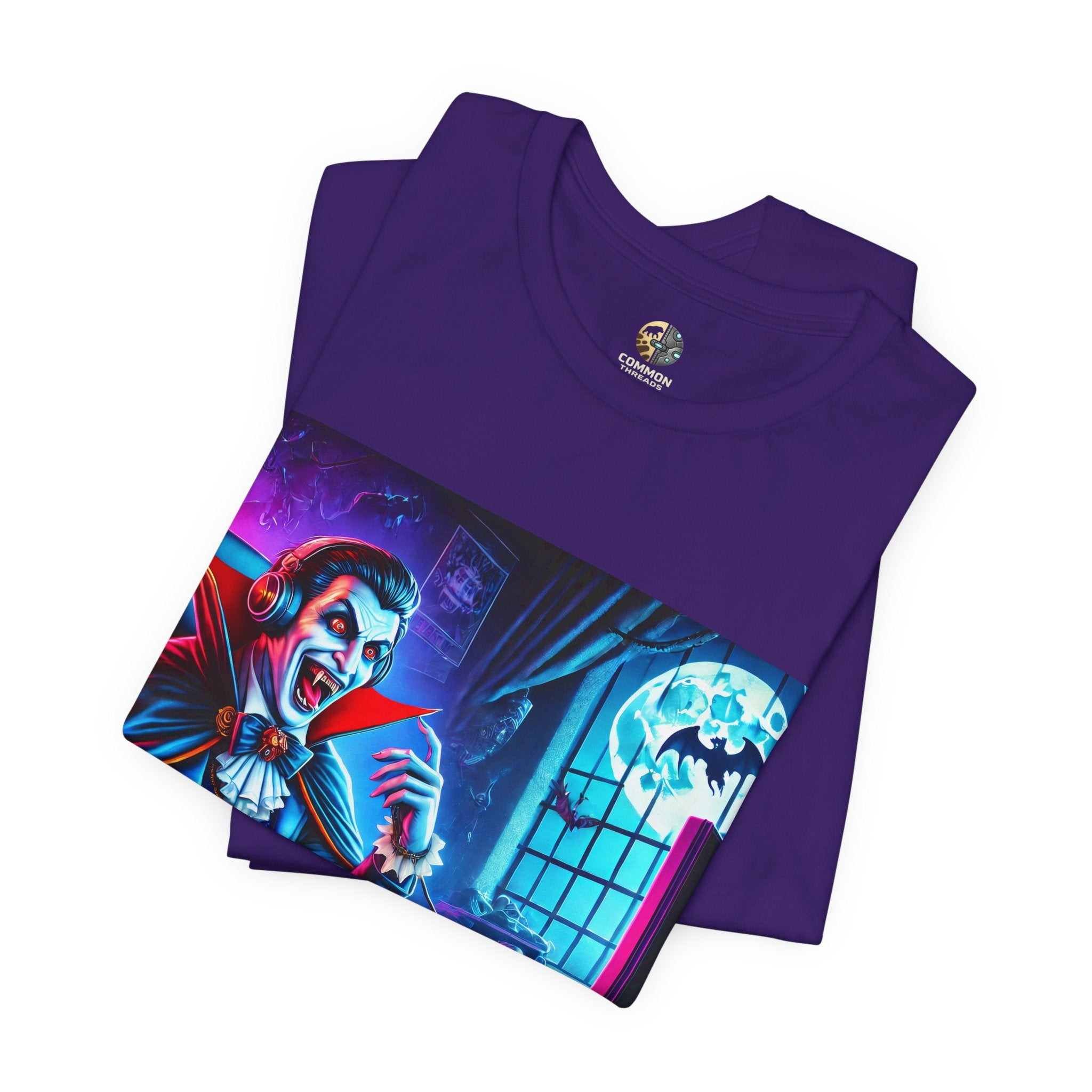 A close up of a purple t-shirt of a vampire playing video games in night time
