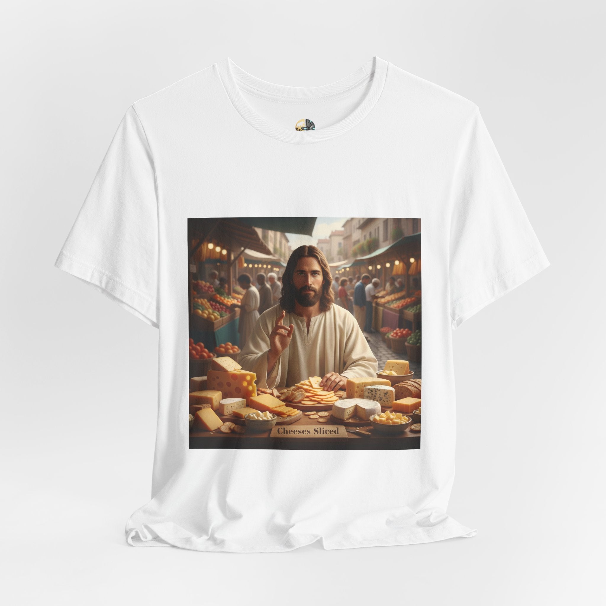 White T-shirt featuring a graphic of Jesus in traditional robes at an ancient marketplace selling assorted cheeses, with a sign reading ‘Cheeses Sliced‘