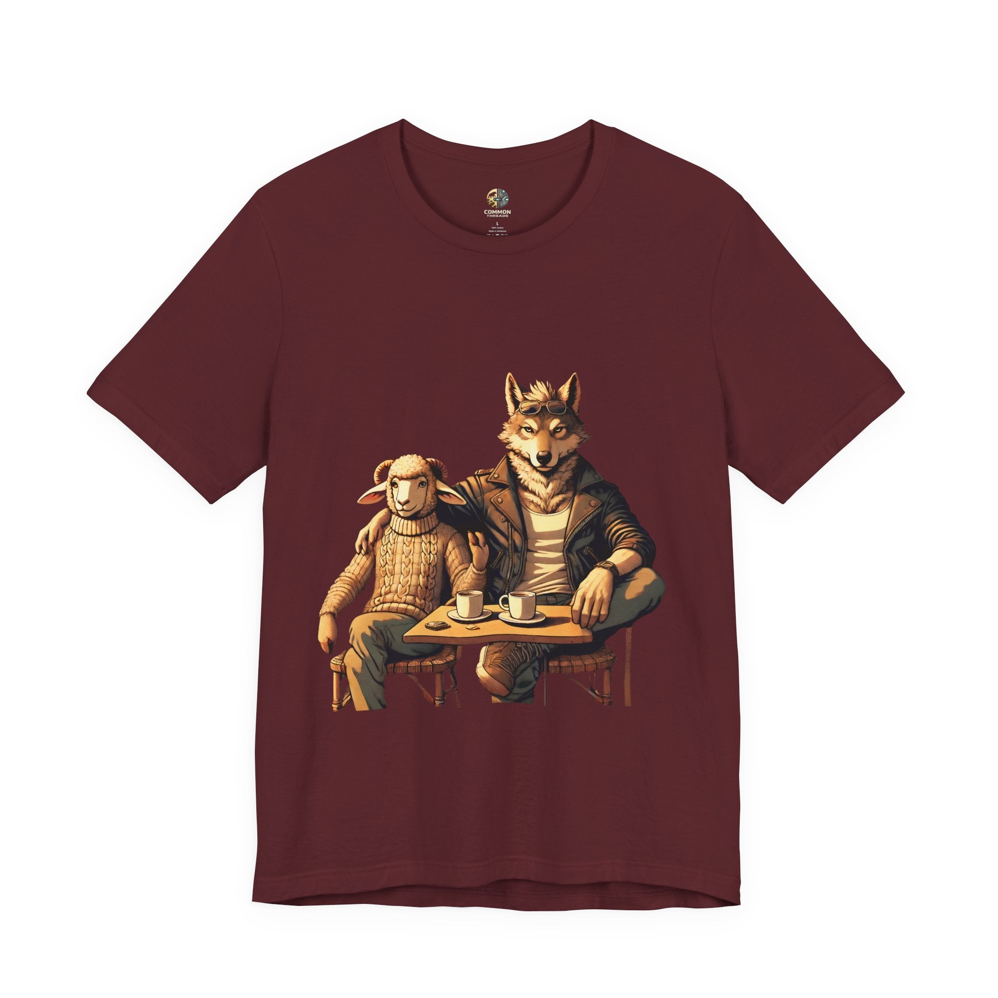 Maroon color T-shirt featuring an anthropomorphic wolf and lamb seated at a café table with coffee cups, illustrated in warm, painterly tones