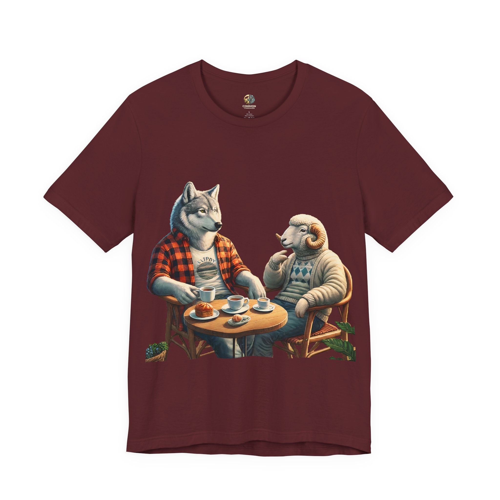 Maroon color T-shirt featuring an anthropomorphic wolf in a flannel shirt and a ram in a patterned sweater sitting at a café table with coffee