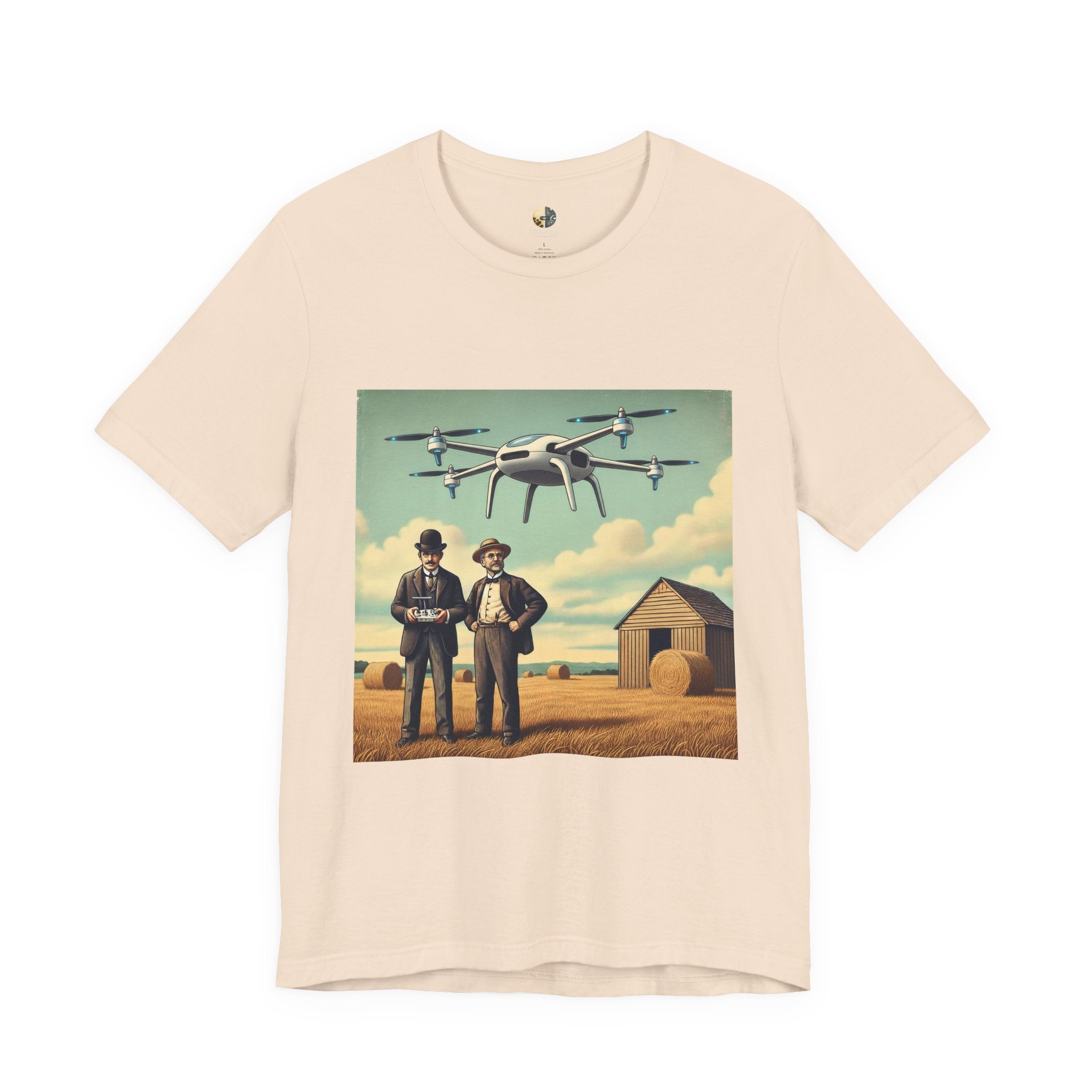 Soft creme T-shirt featuring a graphic of the Wright brothers standing in a hayfield operating a modern quadcopter drone