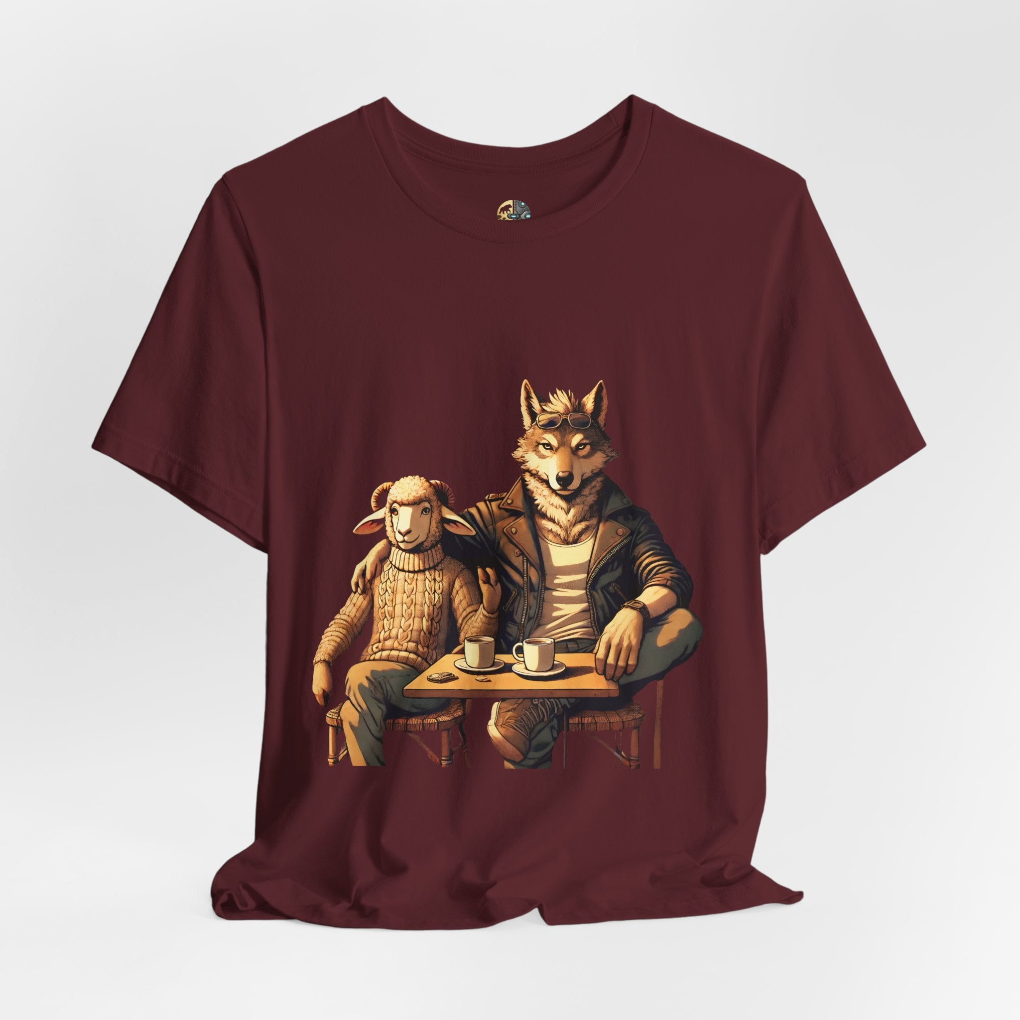 Maroon color T-shirt featuring an anthropomorphic wolf and lamb seated at a café table with coffee cups, illustrated in warm, painterly tones