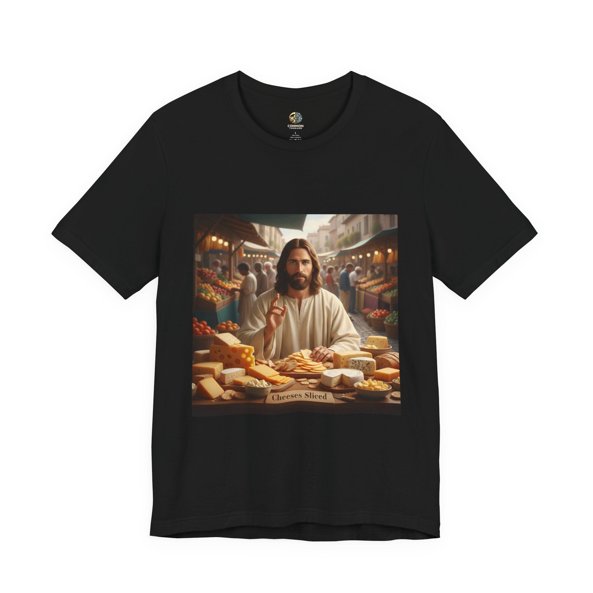 Black T-shirt featuring a graphic of Jesus in traditional robes at an ancient marketplace selling assorted cheeses, with a sign reading ‘Cheeses Sliced‘