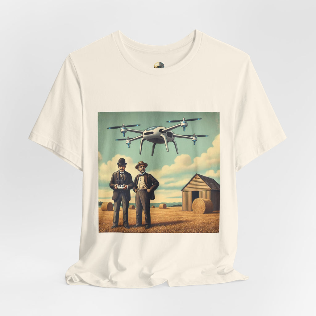 Natural color T-shirt featuring a graphic of the Wright brothers standing in a hayfield operating a modern quadcopter drone