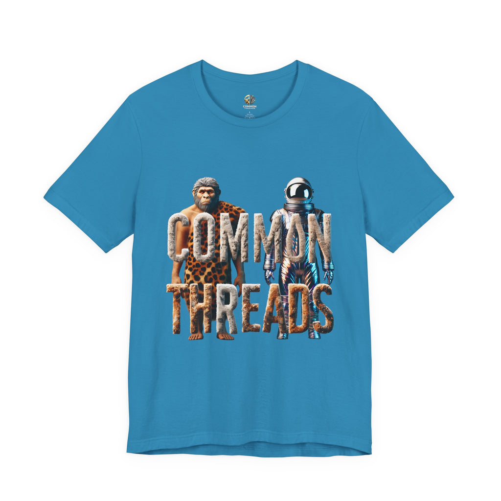 Aqua blue T-shirt featuring a graphic of a caveman in animal pelts standing beside a chrome-plated astronaut, with the text ‘Common Threads‘