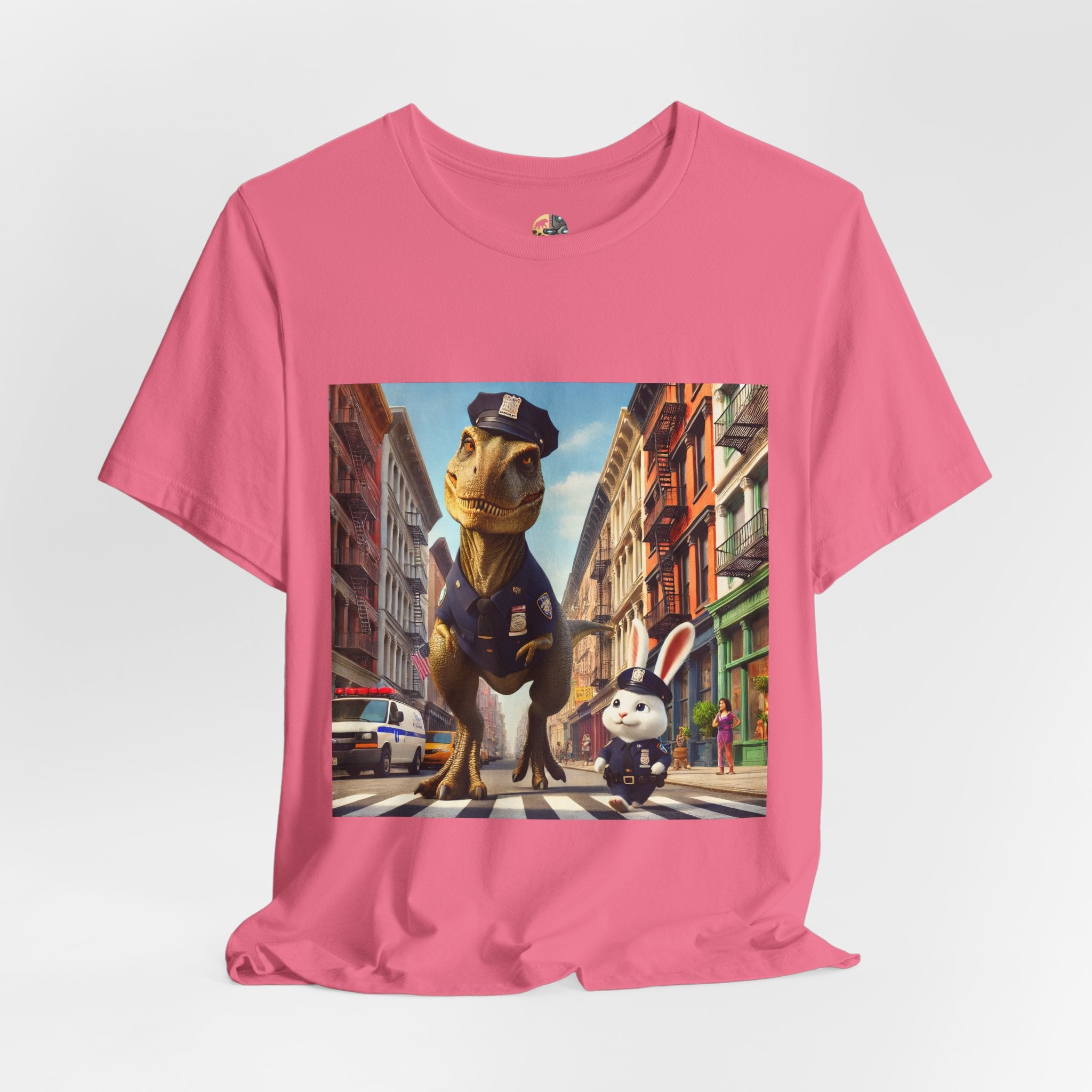 Charity pink T-shirt showing a T-Rex and a bunny dressed as police officers standing together on a crosswalk in a New York–style urban setting