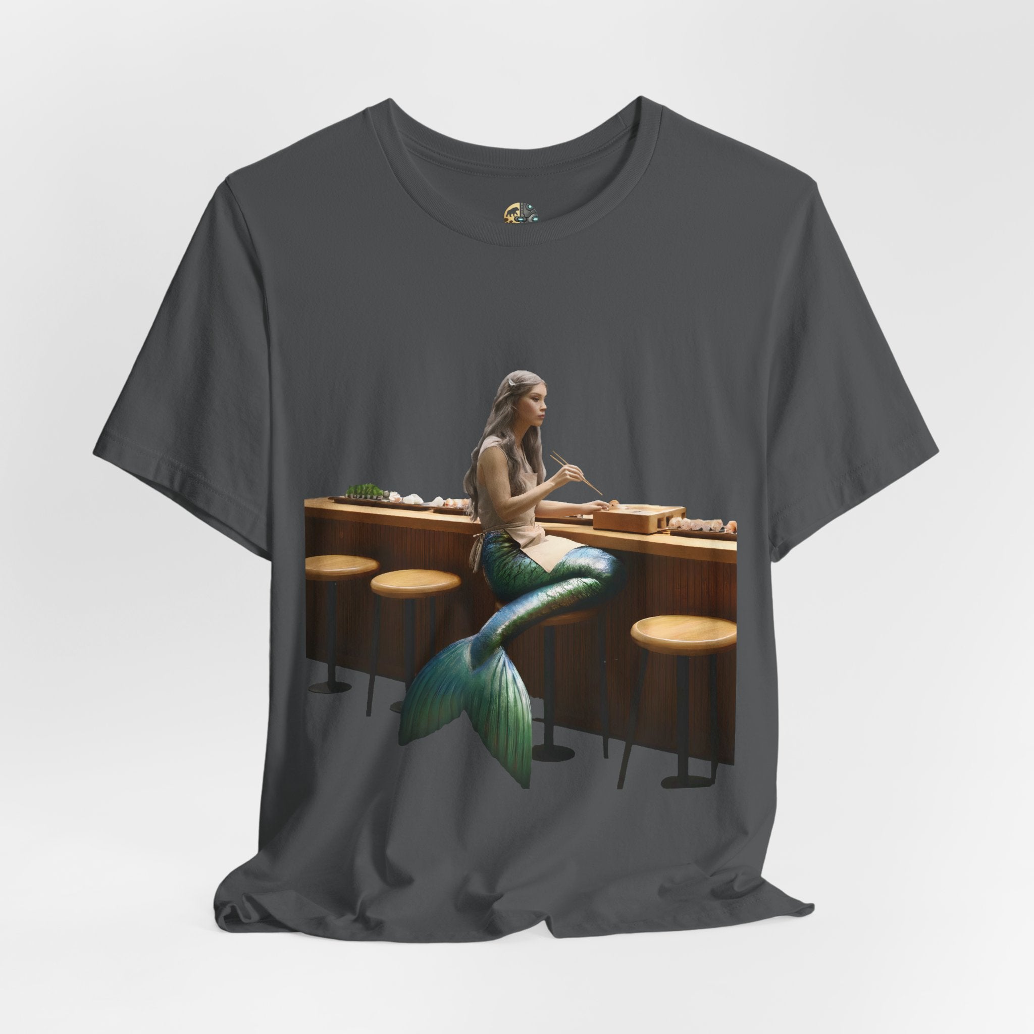 Asphalt grey T-shirt with graphic of a mermaid wearing a chef’s apron sitting at a sushi bar and eating sushi with chopsticks